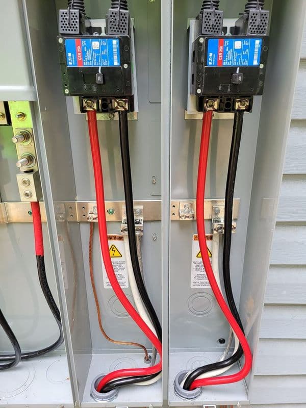 Electrical panel with circuit breakers and color-coded wires for safety and connectivity.